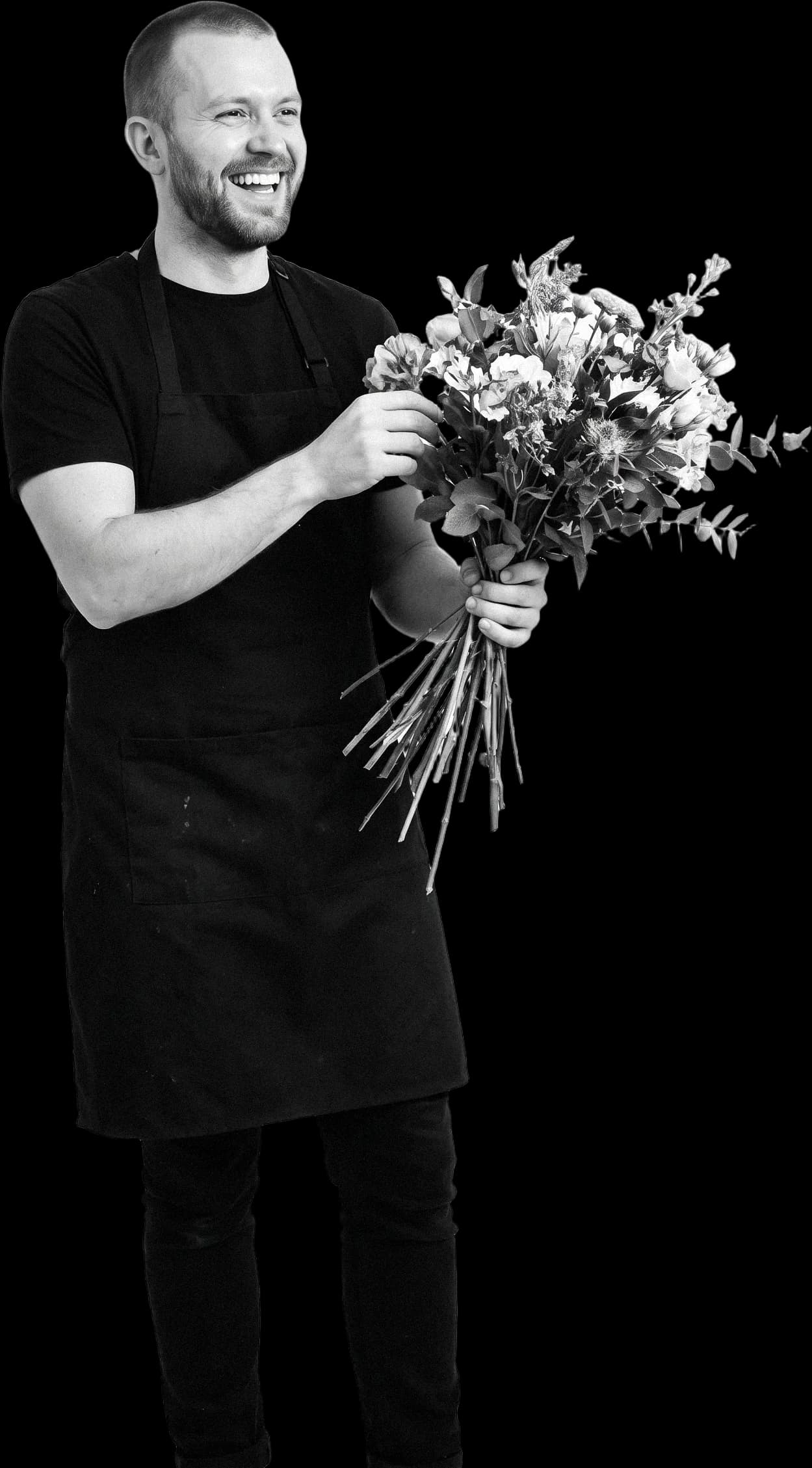 A florist laughing as he arranges a bouquet