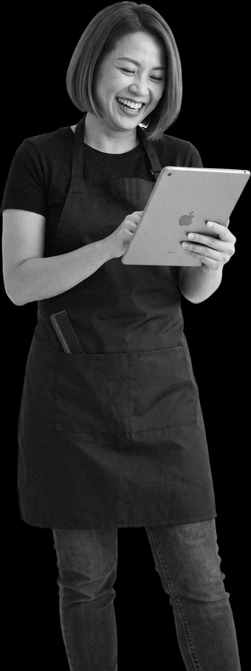 A hairdresser laughing at the iPad in her hands