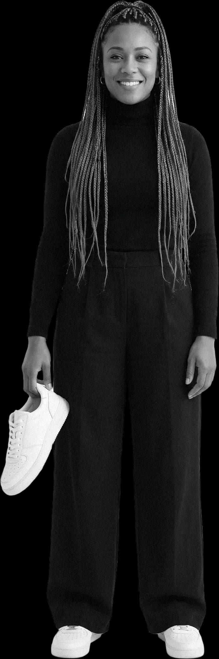 A shoe shop owner holding a sneaker, smiling